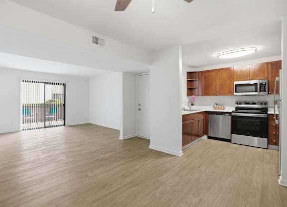 A kitchen with wooden cabinets and stainless steel appliances.