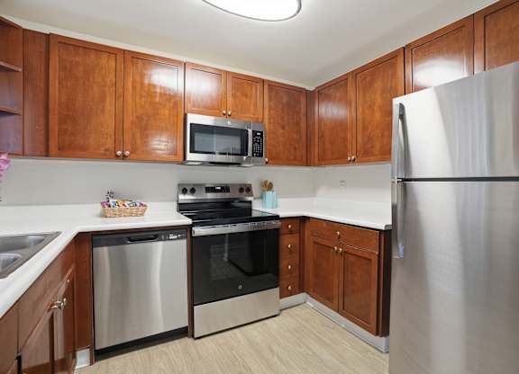A kitchen with wooden cabinets and stainless steel appliances.