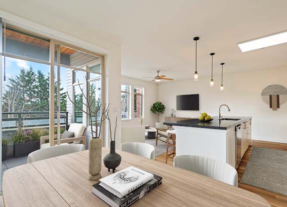 A modern kitchen with a dining table and chairs.