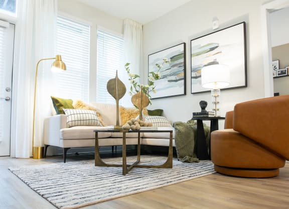 a living room with a couch and a ceiling fan