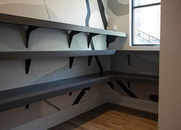 a large grey shelf in a room with a window