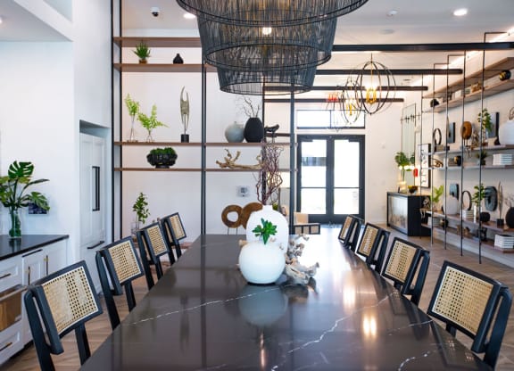 a dining room with a long table and chairs and a large chandelier