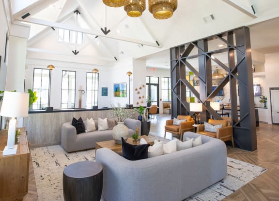 a living room with couches and chairs and a large window