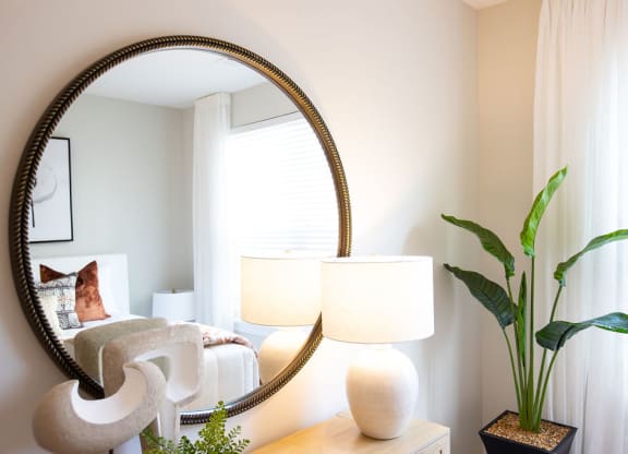 a bedroom with a large mirror on the wall