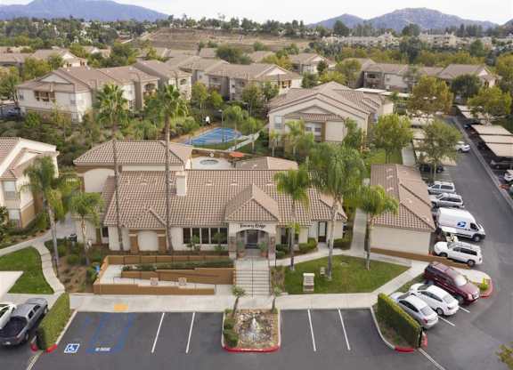 A large building with a pool in the middle of a parking lot.