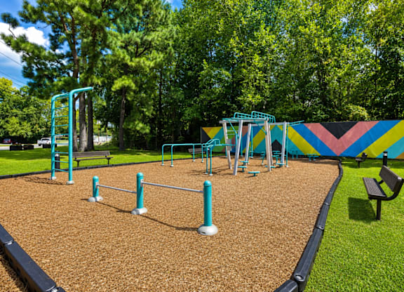 A playground with a slide, swings, and a climbing frame.