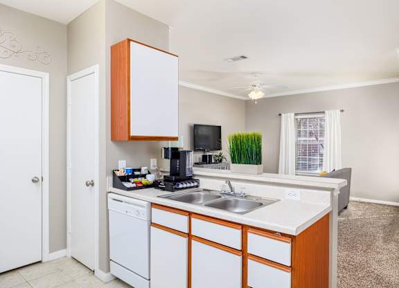 A kitchen with white cabinets and a white dishwasher at Clear Creek Meadows Apartments, Apartments, Copperas Cove, TX