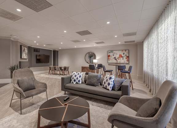 a living room with couches and chairs and a table