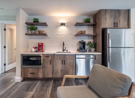 a kitchen with stainless steel appliances and a stainless steel refrigerator