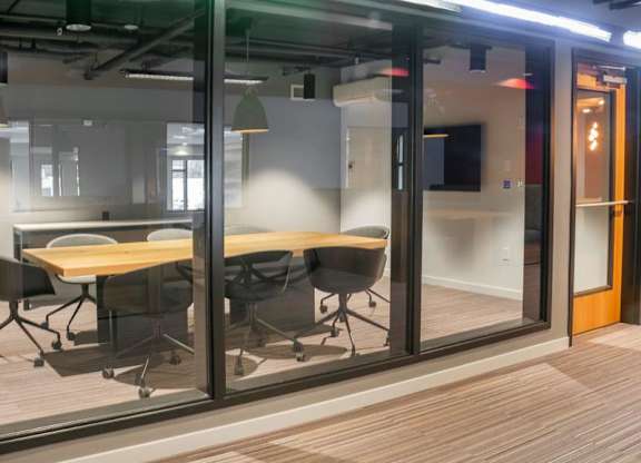 A conference room with a wooden table and chairs.at Axle, Seattle, WA 