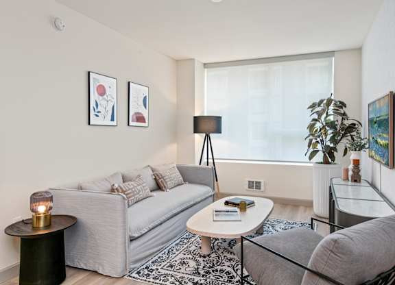 a living room with a couch coffee table and a window