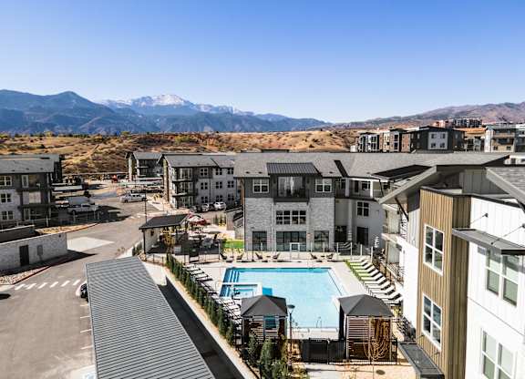 Aerial view of an apartment complex with a pool at The Allaso Peak, Colorado, 80907