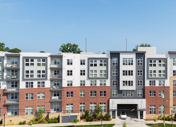 A large multi-story building with a mix of brick and white exterior walls.