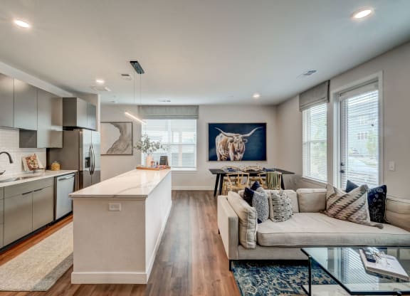 a living room with a kitchen and a couch