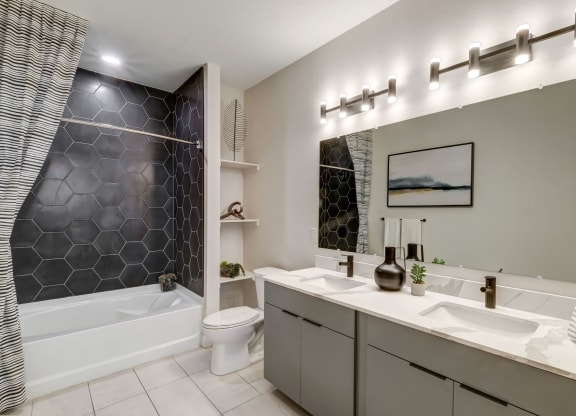 a bathroom with a sink and a toilet and a tub