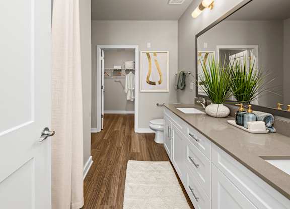 A bathroom with a white door and a white sink.