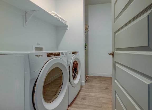 a washer and dryer in a laundry room with a white door