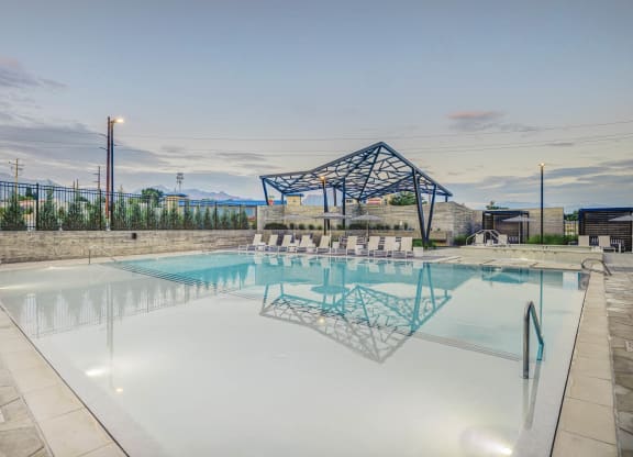 a large pool with a shade structure in the background