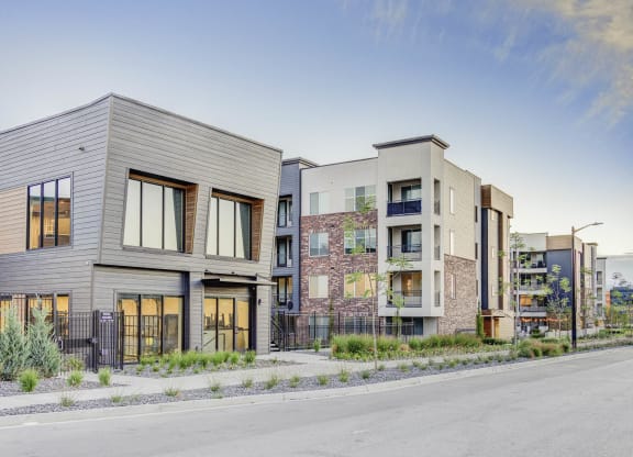 a row of modern apartment buildings with a street in the foreground