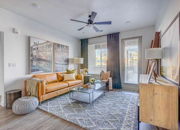a living room with a couch and a ceiling fan