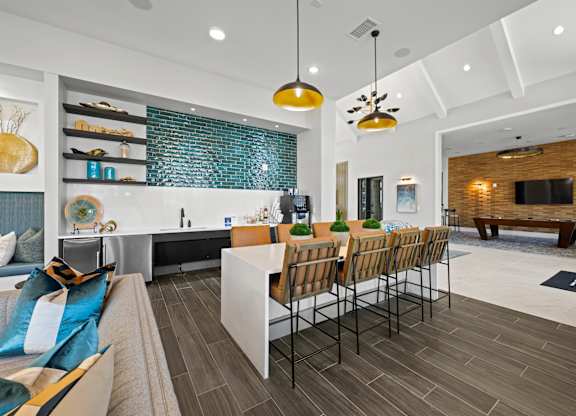 A modern kitchen with a dining table and chairs.