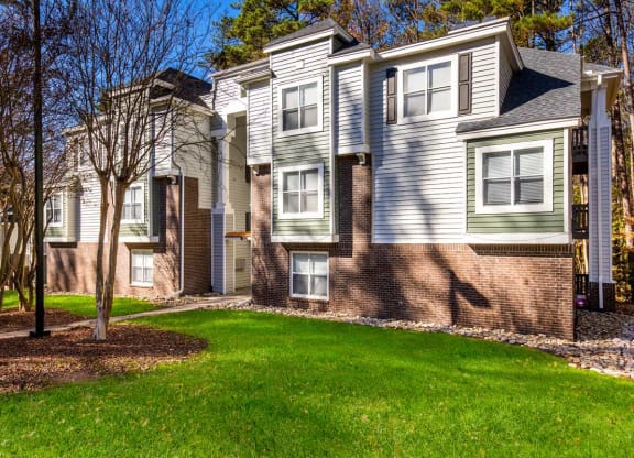a large green lawn in front of an apartment building