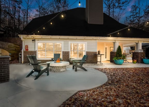 a circular concrete patio with a fire pit in the middle