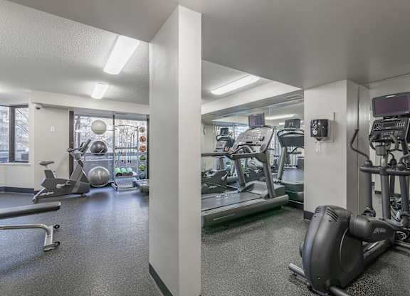a gym with treadmills and other exercise equipment in a building