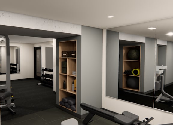 A gym with a variety of equipment including a bench press, a squat rack, and a rowing machine.