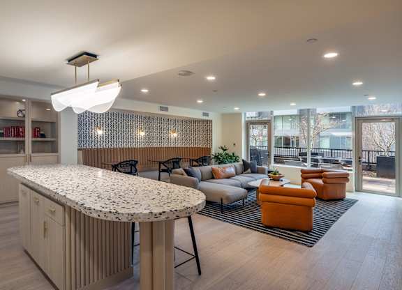 a clubhouse with a bar and a living room with couches