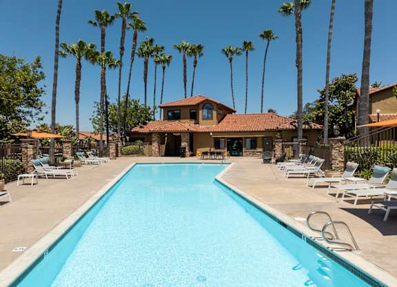 Swimming pool with chairs and a house in the background at Bella Terra, Vista
