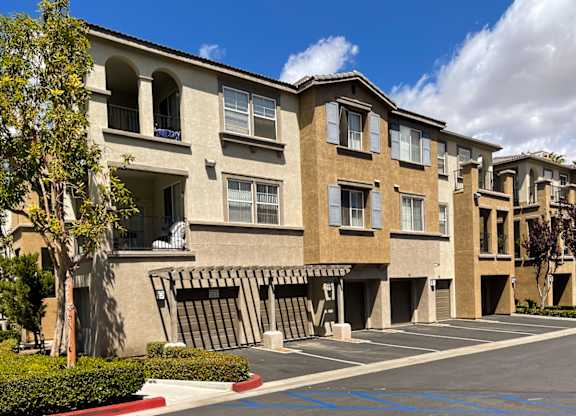 A row of apartment buildings with a clear blue sky above.