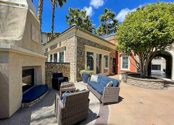 A patio with a fireplace and furniture.