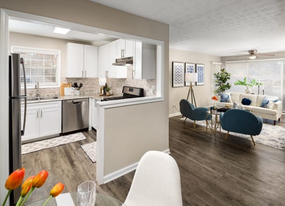 a living room with a kitchen and a dining room