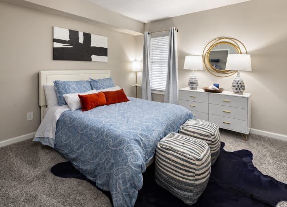 a blue and white bedroom with a bed and pillows