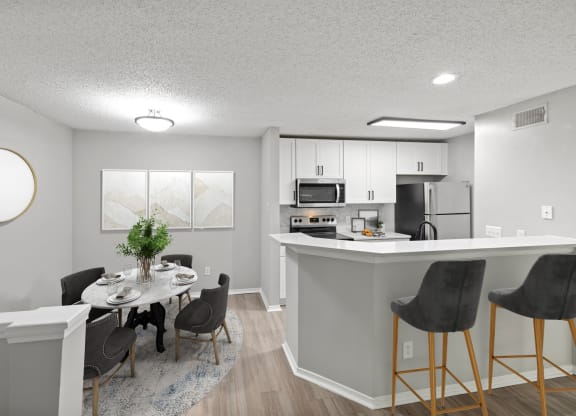 an open kitchen and dining room with a table and chairs