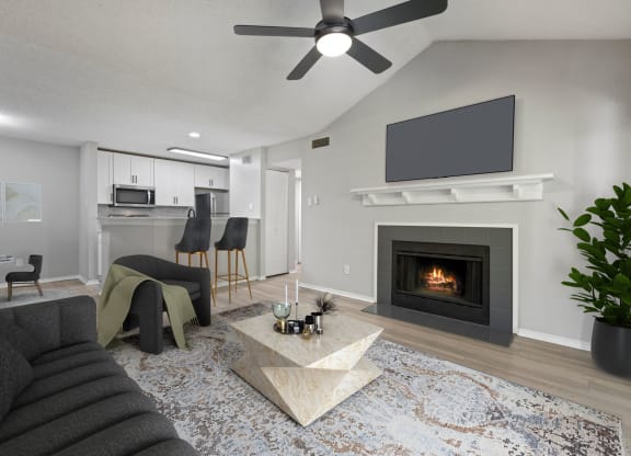 a living room with a fireplace and a tv