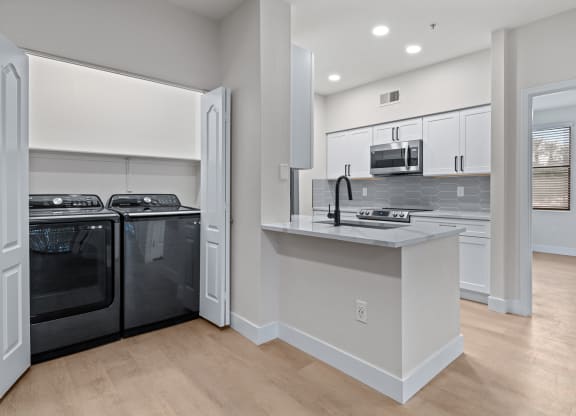 a kitchen with white cabinets and a white counter top
