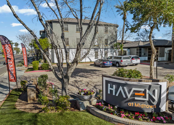 a building with a sign in front of a parking lot