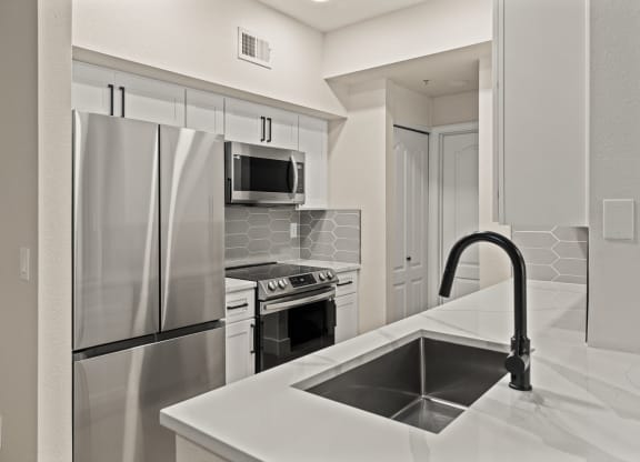a kitchen with a sink and a refrigerator