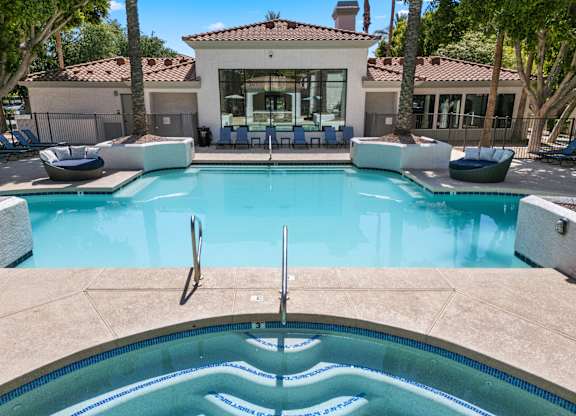 A sparkling pool with relaxing hot tub.