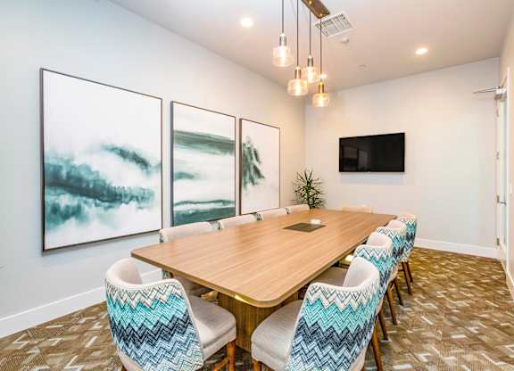 A conference room with a long table and chairs.