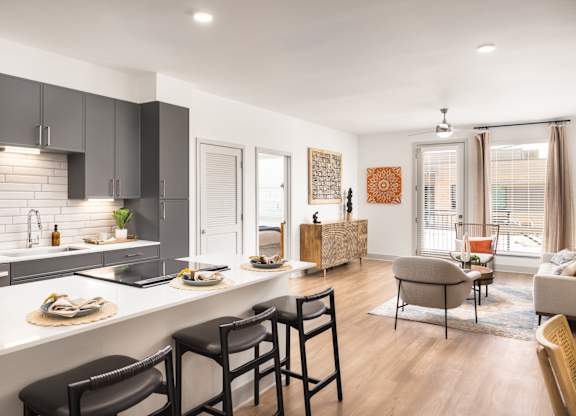 A modern kitchen with a dining table and chairs.