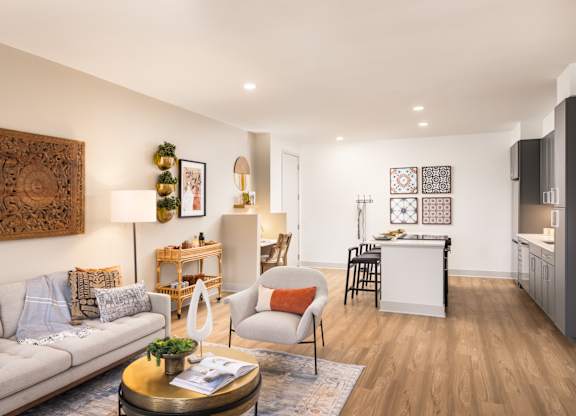 A living room with a grey sofa, a coffee table, and a wooden wall hanging.