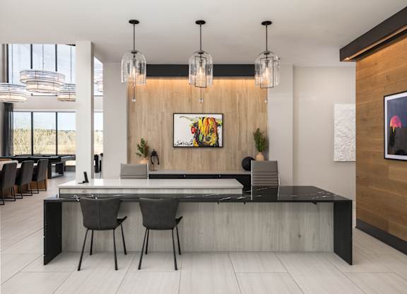 A modern dining room with a long table and chairs.