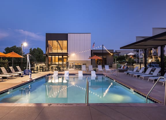 A swimming pool with a building in the background.