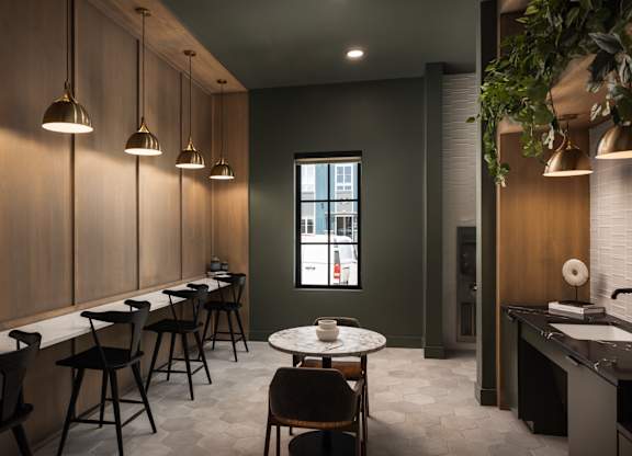 A modern dining area with a long table and chairs.