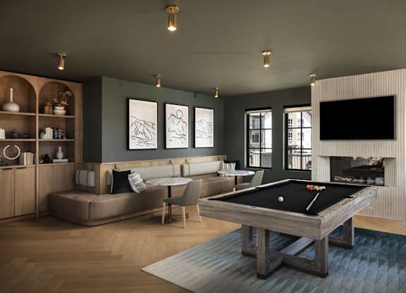 A pool table is in the middle of a living room.