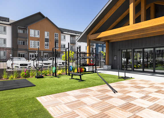 A playground with a slide and a wooden deck.