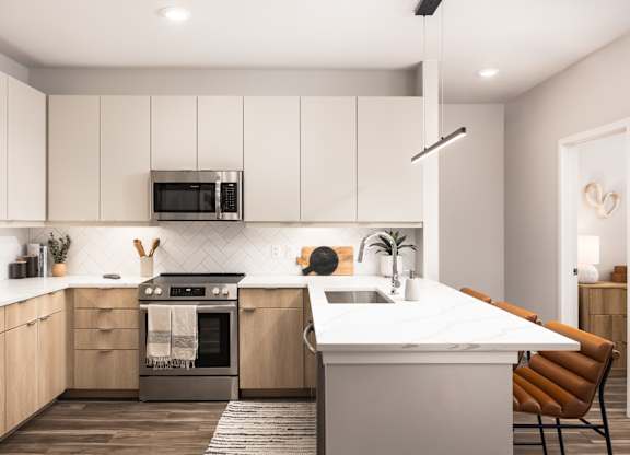 A modern kitchen with a white countertop and wooden cabinets.